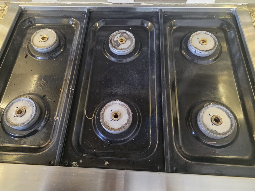 Gas range, burners and drip pans - before cleaning